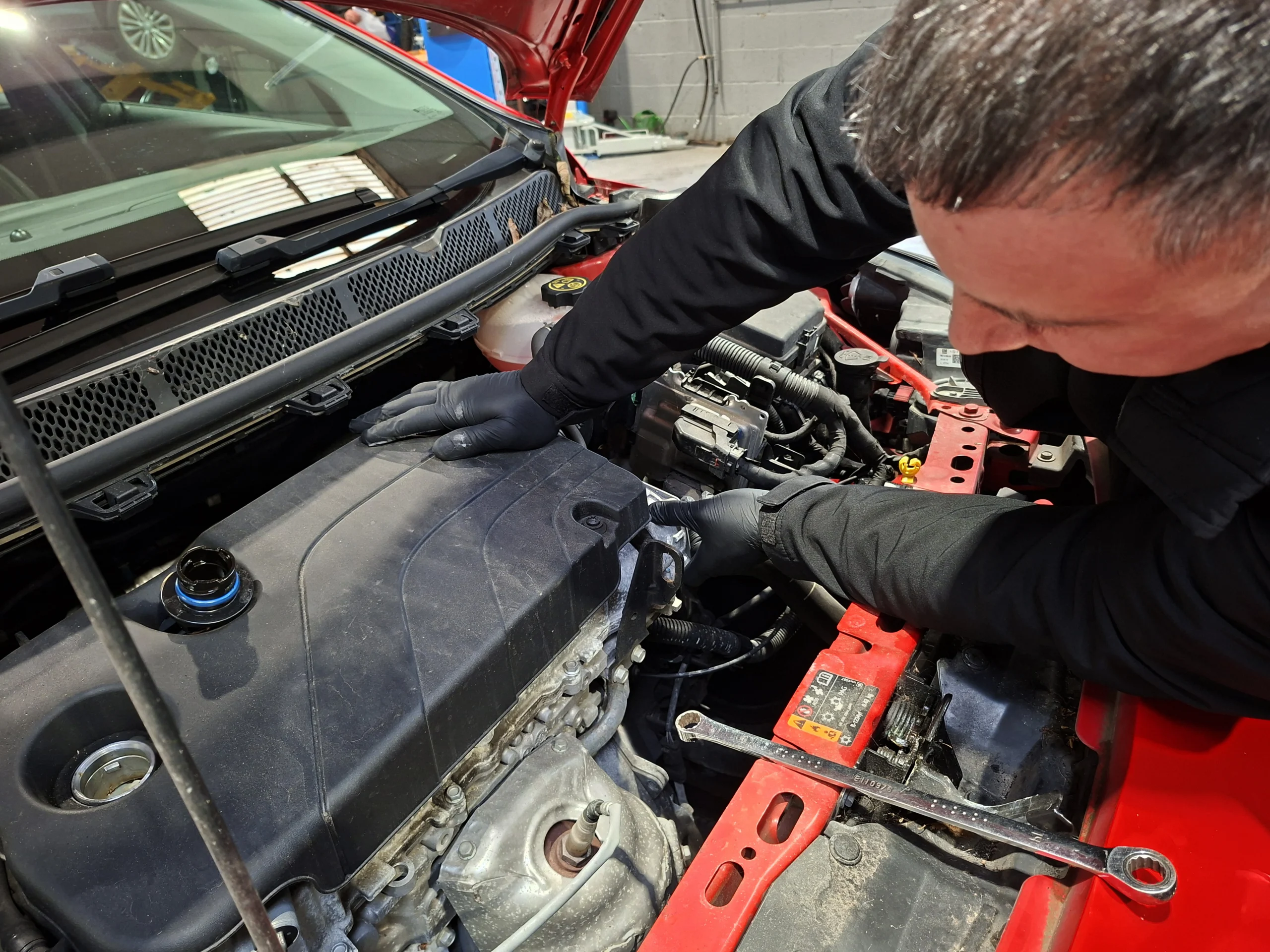 Mechanic at work on timing belt